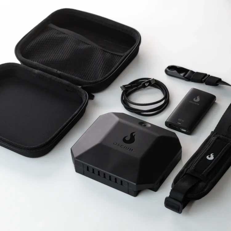 Oscium Nomad package contents including device, USB-C cables, wearable strap, and carrying case